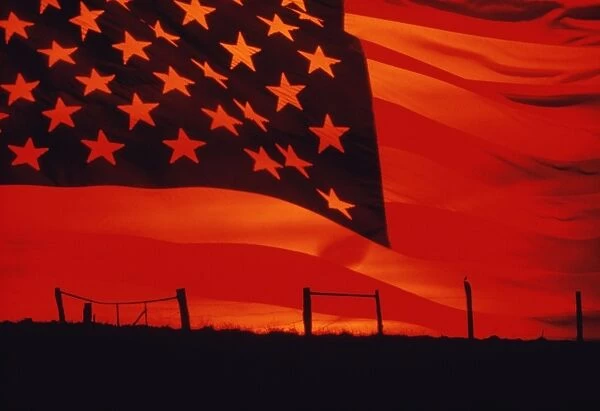 Digital composite of the American Flag over the countryside