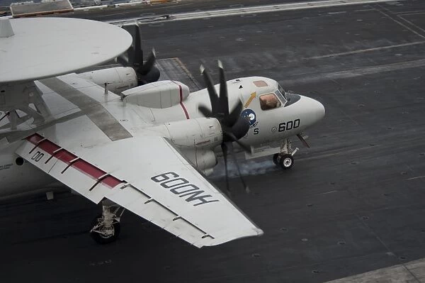 An E-2C Hawkeye lands on the flight deck of USS Nimitz