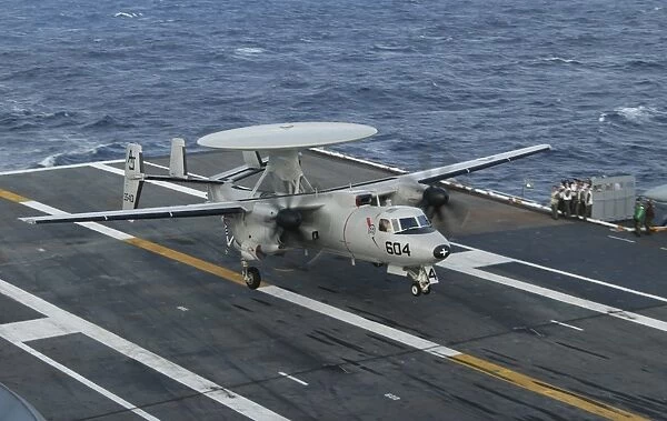 An E-2C Hawkeye is recovered during flight deck operations aboard USS Theodore Roosevelt