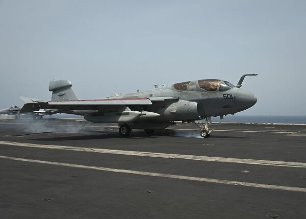 An EA-6B Prowler lands on the flight deck of USS Nimitz
