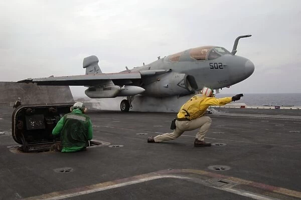 An EA-6B Prowler launches off the flight deck of USS Kitty Hawk