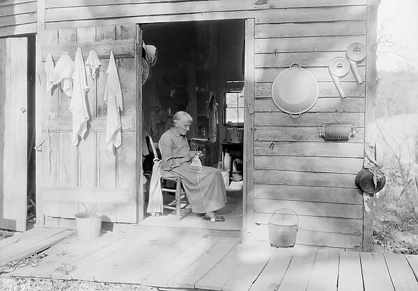 An elder woman knitting on a farm near Bulls Gap, Tennessee, 1933