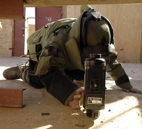 An EOD member places an x-ray machine near an Improvised Explosive Device