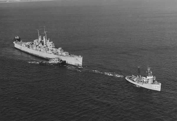 Ex-USS Vincennes is towed out of San Diego Bay, California, by USS Kalmia, 1969