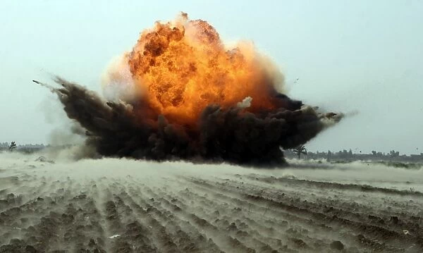 An explosion erupts from the detonation of a weapons cache
