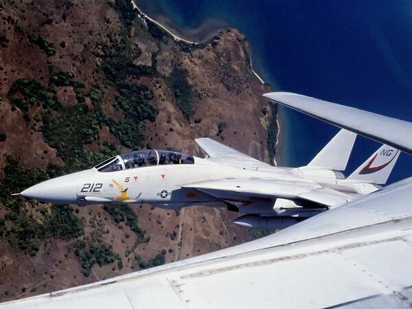 F-14 Tomcat wingman tucks into a tight formation over the Philippines