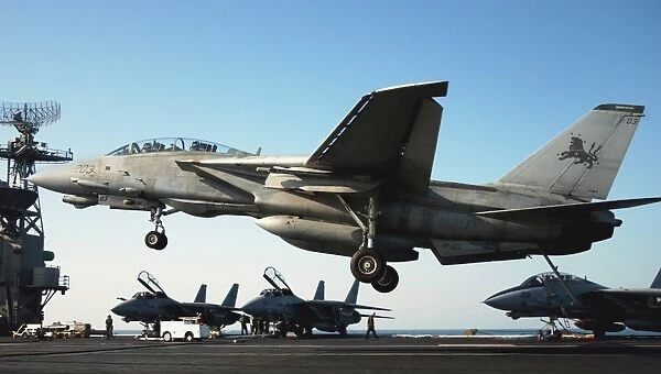 An F-14D Tomcat prepares to land on the flight deck of USS Theodore Roosevelt