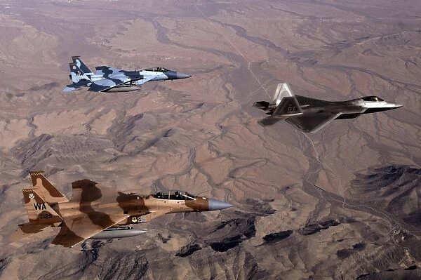Two F-15 Agressor Eagles fly in formation with a F-22 Raptor