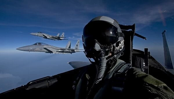 Three F-15 Eagles fly high during a training mission