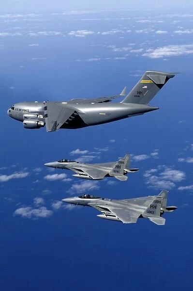 F-15B Eagles escort the first Hawaii-based C-17 Globemaster III to its home