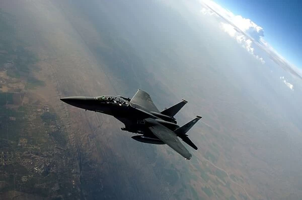 An F-15E Strike Eagle breaks away from a KC-135 Stratotanker after refueling
