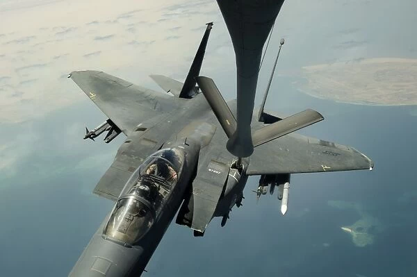 An F-15E Strike Eagle receives fuel from a KC-135R Stratotanker