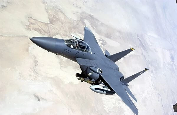 An F-15E Strike Eagle turns away after recieving fuel