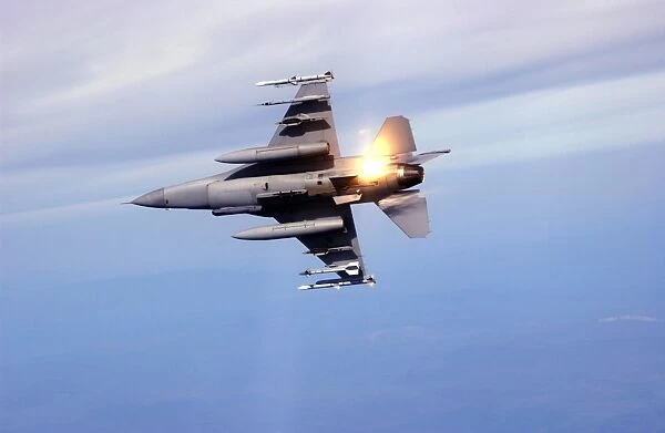 An F-16 Fighting Falcon drops flares while performing manuevers