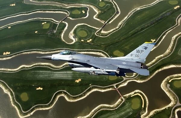 An F-16 Fighting Falcon flies near base