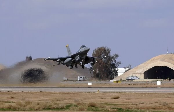 An F-16 Fighting Falcon takes off from Balad Air Base, Iraq