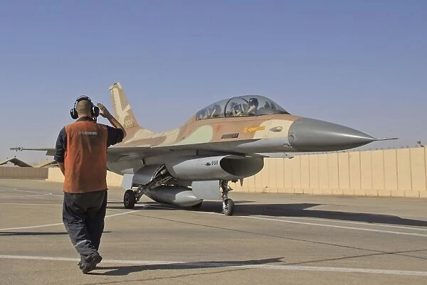 An F-16B Netz of the Israeli Air Force gets the take off sign from the ground crew