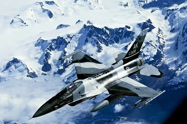 An F-16C Falcon from the 18th Aggressor Squadron flies over an Alaskan mountain range