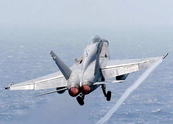 An F  /  A-18 Hornet taking off