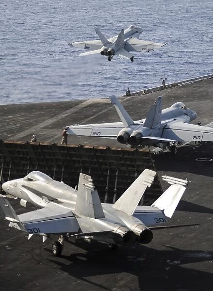F  /  A-18 Hornets prepare to launch from the flight deck of USS Nimitz
