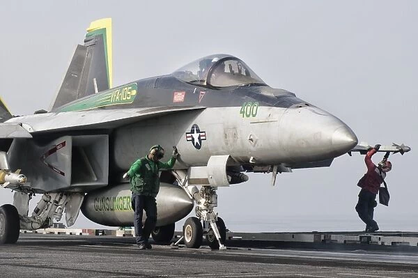 An F  /  A-18 Super Hornet is ready to launch from a catapult aboard USS Harry S. Truman
