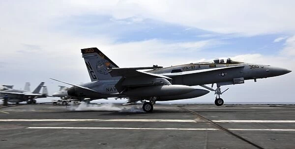 An F  /  A-18C Hornet lands aboard the Nimitz-class aircraft carrier USS John C. Stennis