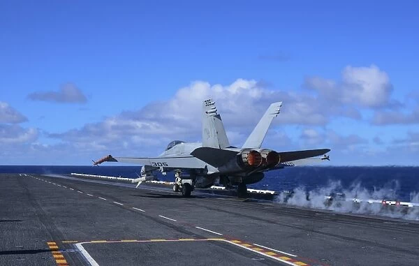 An F  /  A-18C Hornet launches from aircraft carrier USS Carl Vinson