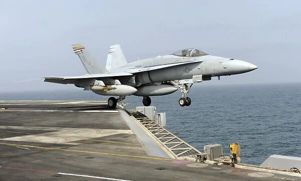 An F  /  A-18C Hornet launches from the aircraft carrier USS Harry S. Truman