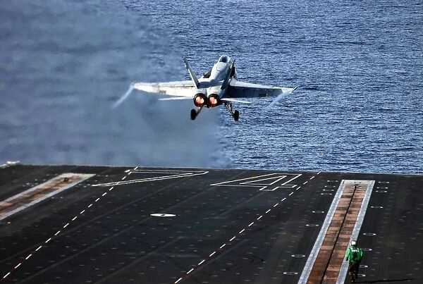 An F  /  A-18C Hornet launches from aircraft carrier USS John C. Stennis
