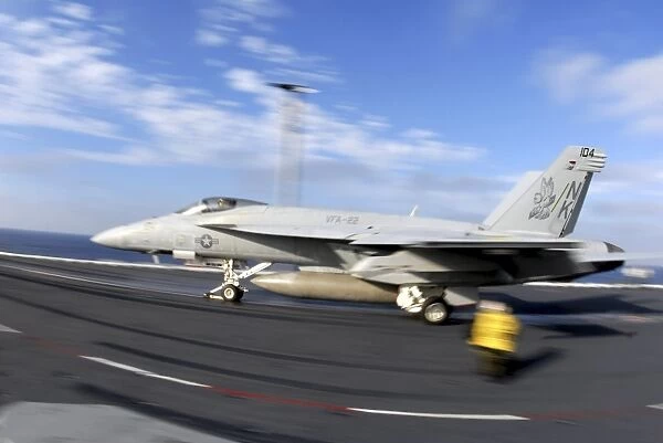 An F  /  A-18C Hornet launches from the flight deck aboard USS Nimitz