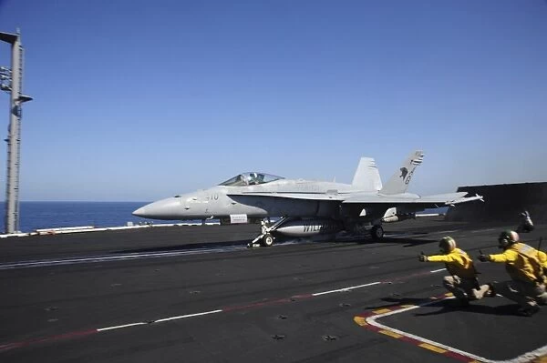 An F  /  A-18C Hornet launches from the flight deck of USS Dwight D. Eisenhower