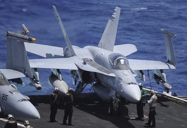 An F  /  A-18C Hornet sits ready for take off from the flight deck of USS Nimitz