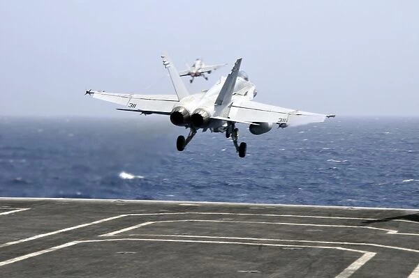 Two F  /  A-18C Hornet strike fighters launch from the aircraft carrier USS Ronald Reagan