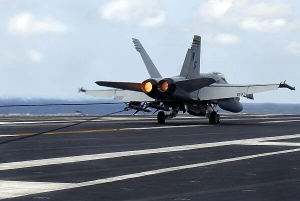 An F  /  A-18C Hornet successfully lands on the flight deck of USS John C. Stennis