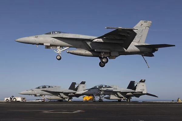 An F  /  A-18E Super Hornet comes in for an arrested landing