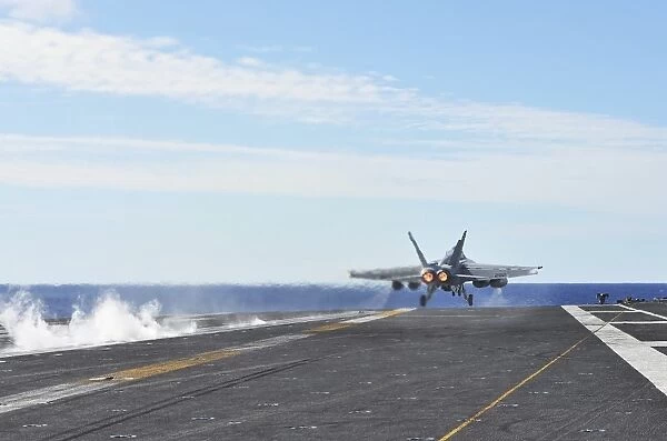 An F  /  A-18E Super Hornet launches from the flight deck of USS George Washington