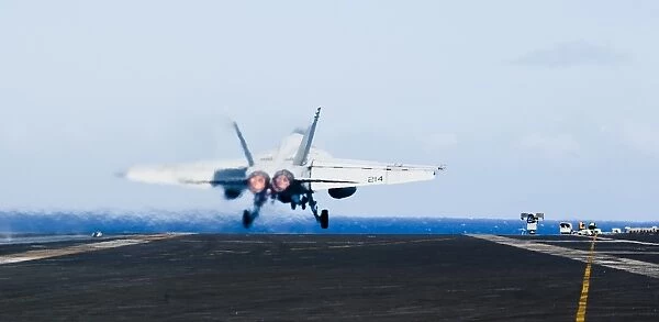 An F  /  A-18E Super Hornet launches off the flight deck of USS John C. Stennis