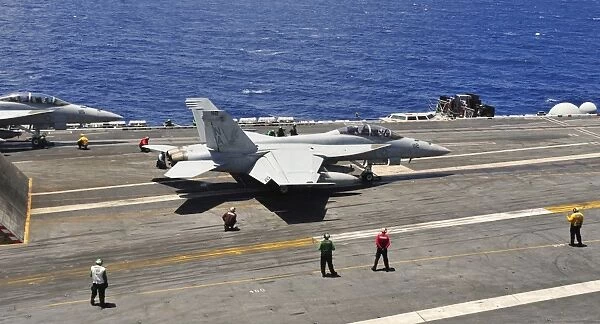 An F  /  A-18E Super Hornet prepares to launch from USS Carl Vinson