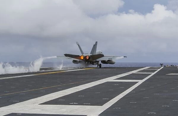 An F  /  A-18E Super Hornet takes off from the flight deck of USS George Washington