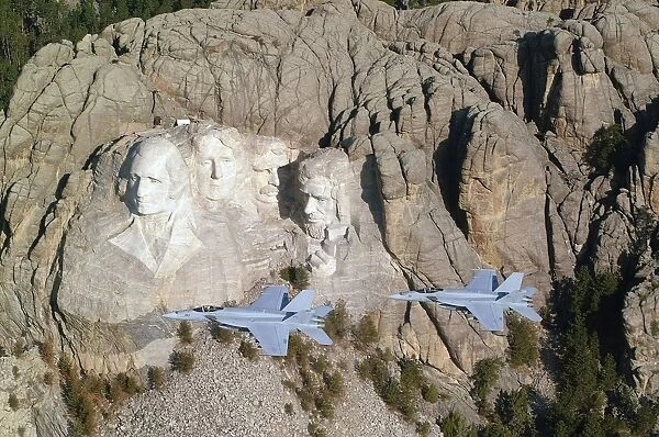 Two F  /  A-18E Super Hornets conduct a fly by of Mount Rushmore