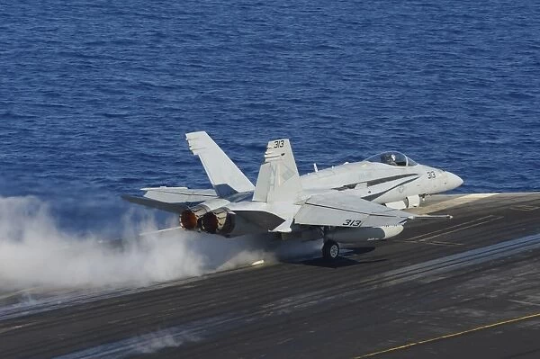 An F  /  A-18F Hornet launches from the flight deck of USS Nimitz