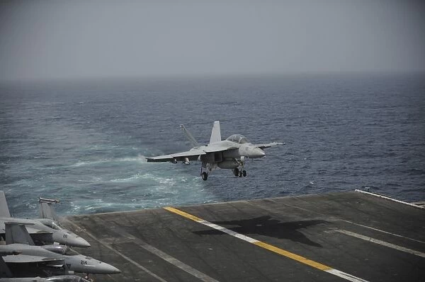 An F  /  A-18F Super Hornet lands on the aircraft carrier USS Nimitz