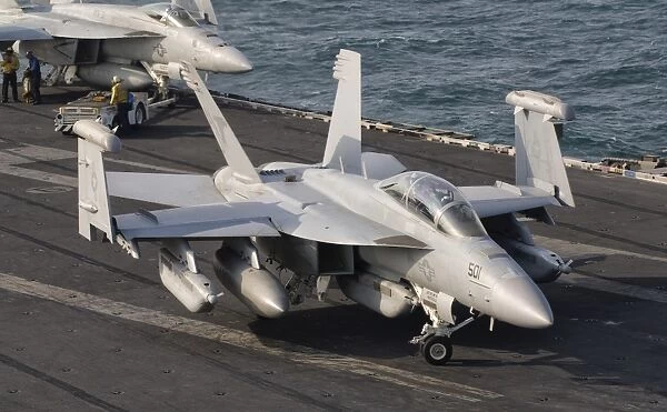 An F  /  A-18F Super Hornet moving to the catapult aboard USS George H. W. Bush