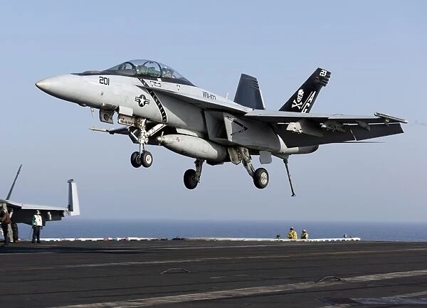 An F  /  A-18F Super Hornet prepares for landing aboard USS Dwight D. Eisenhower