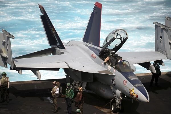 An F  /  A-18F Super Hornet sits on the flight deck of USS Enterprise