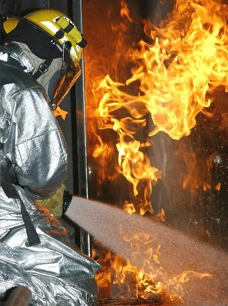 Firefighter extinguishes a simulated structural fire