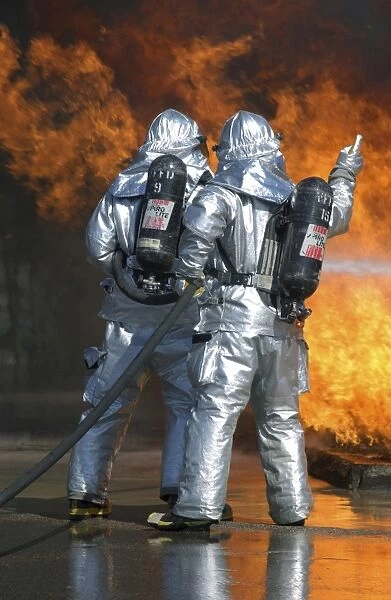 A firefighter fights a fire during a readiness training exercise