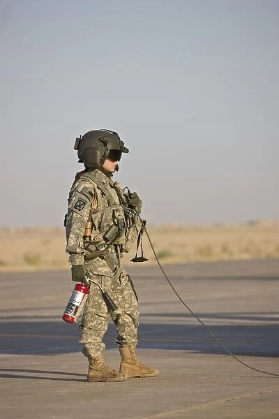 A flight crew member stands by with a fire extinguisher