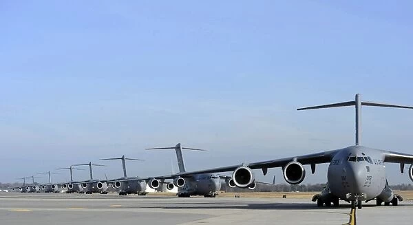 A Formation of U. S. Air Force C-17 Globemaster IIIs prepare for departure