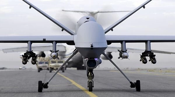 A fully armed MQ-9 Reaper taxis down an Afghanistan runway